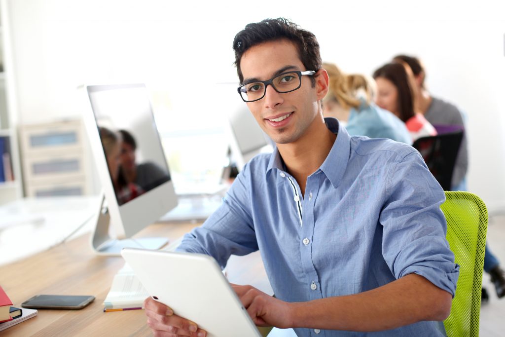 Student in class using digital tablet